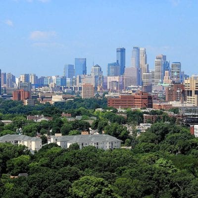 1920px-Minneapolis_skyline_from_Prospect_Park_Water_Tower,_July_2014 By Michael Hicks, CC BY 2.0, https://commons.wikimedia.org/w/index.php?curid=52169247